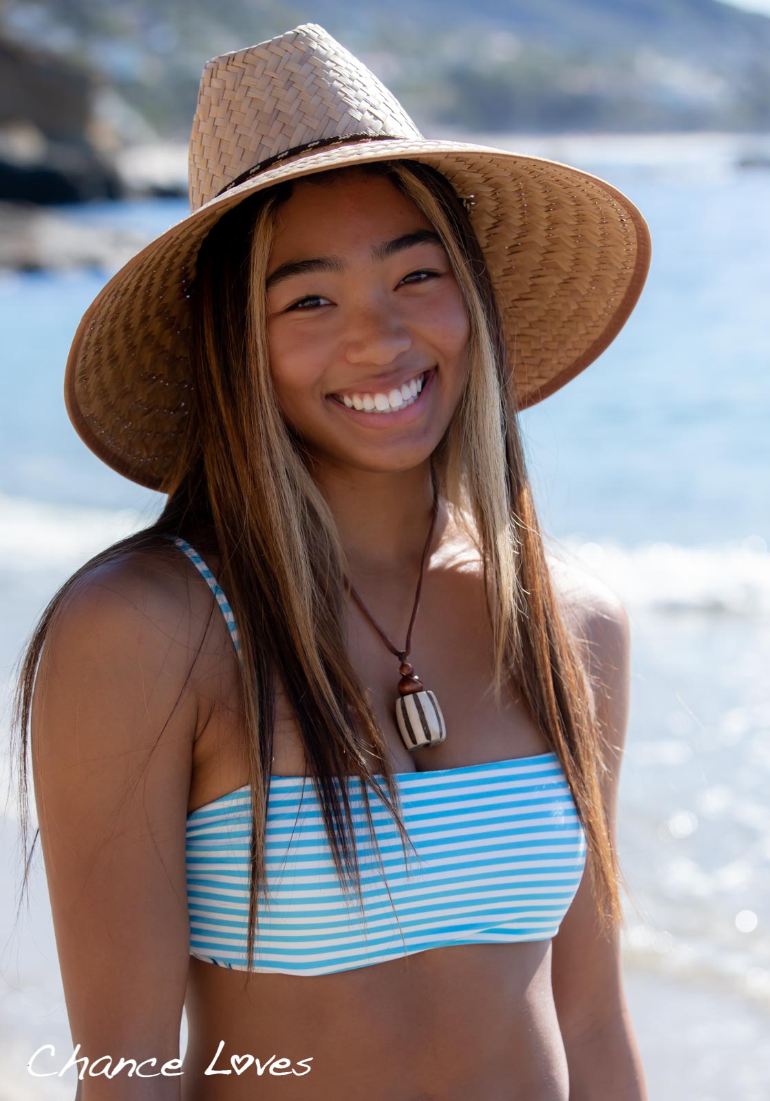 Smiling Junior Girl wears a reversible padded band top design by Chance Loves Swimwear