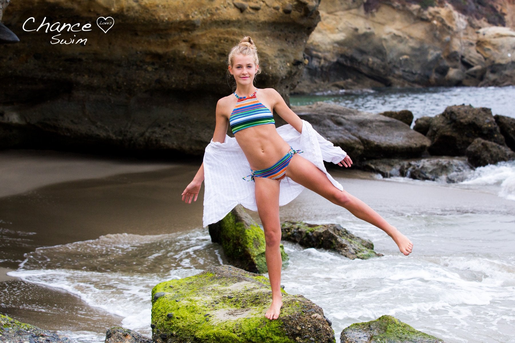 Girl balancing on a rock at the beach wearing the Two Piece Bikini Set with Halter Top desgined by Chance Loves Swimwear