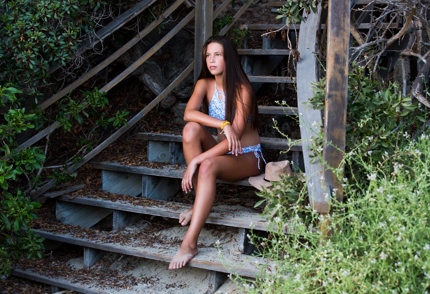 Gazing at the pretty blue water in the Daisy Blue Girls Bikini Set with Halter Top - Chance Loves Swimwear