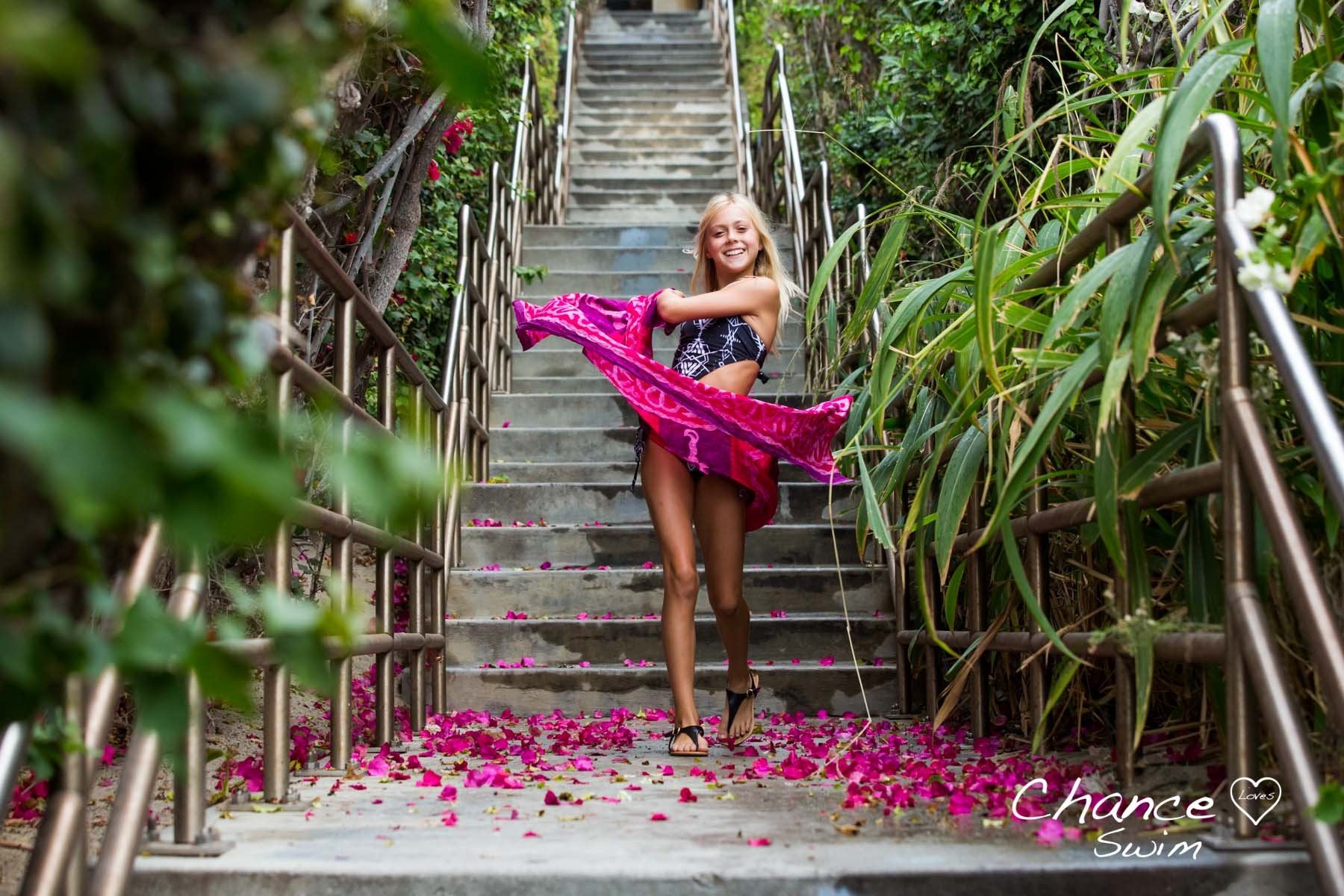 Coming down the stairs and dancing in the rain is 11 year old Chance Colette, designer and founder of Chance Loves Swimwear