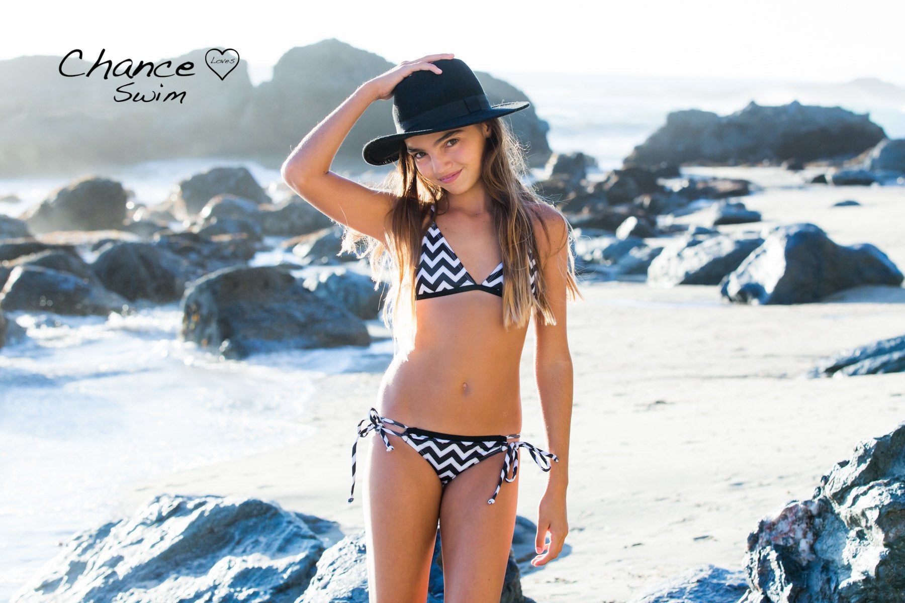 Beachgirl wearing hat wearing a black and white Zig & Zag Bikini designed by Chance Loves Swimwear