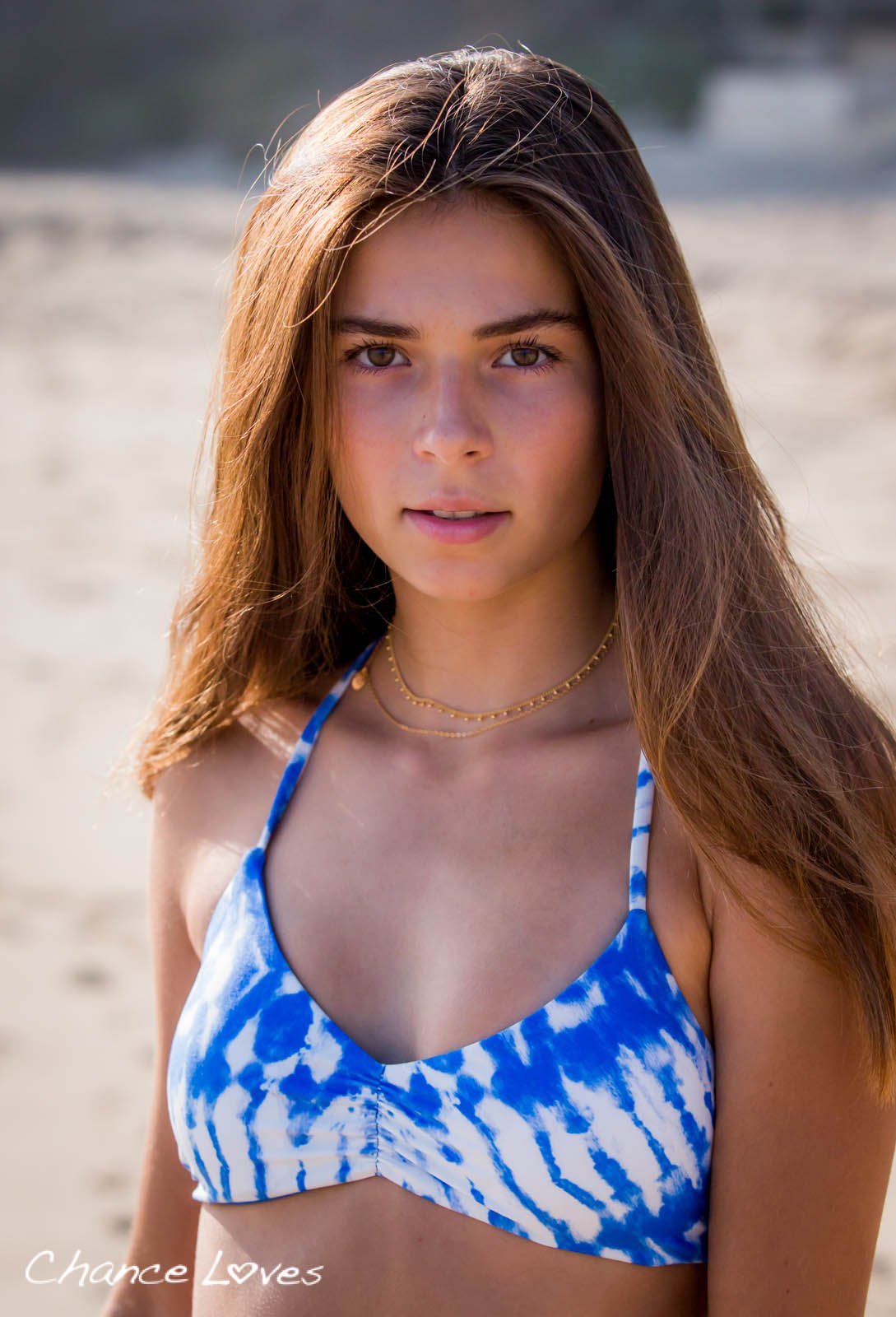Teen girl in a beautiful blue white tie dye padded reversible swimwear top