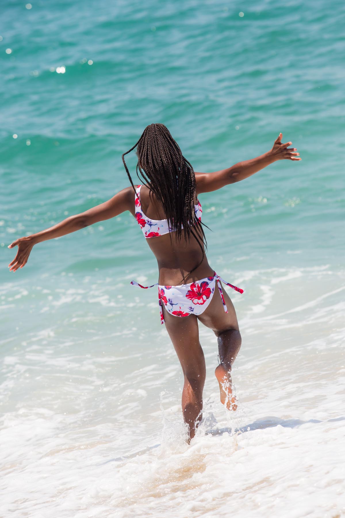 Running into the water wearing the Aloha Spirit Scoop Top Bikini Set - Chance Loves Swimwear