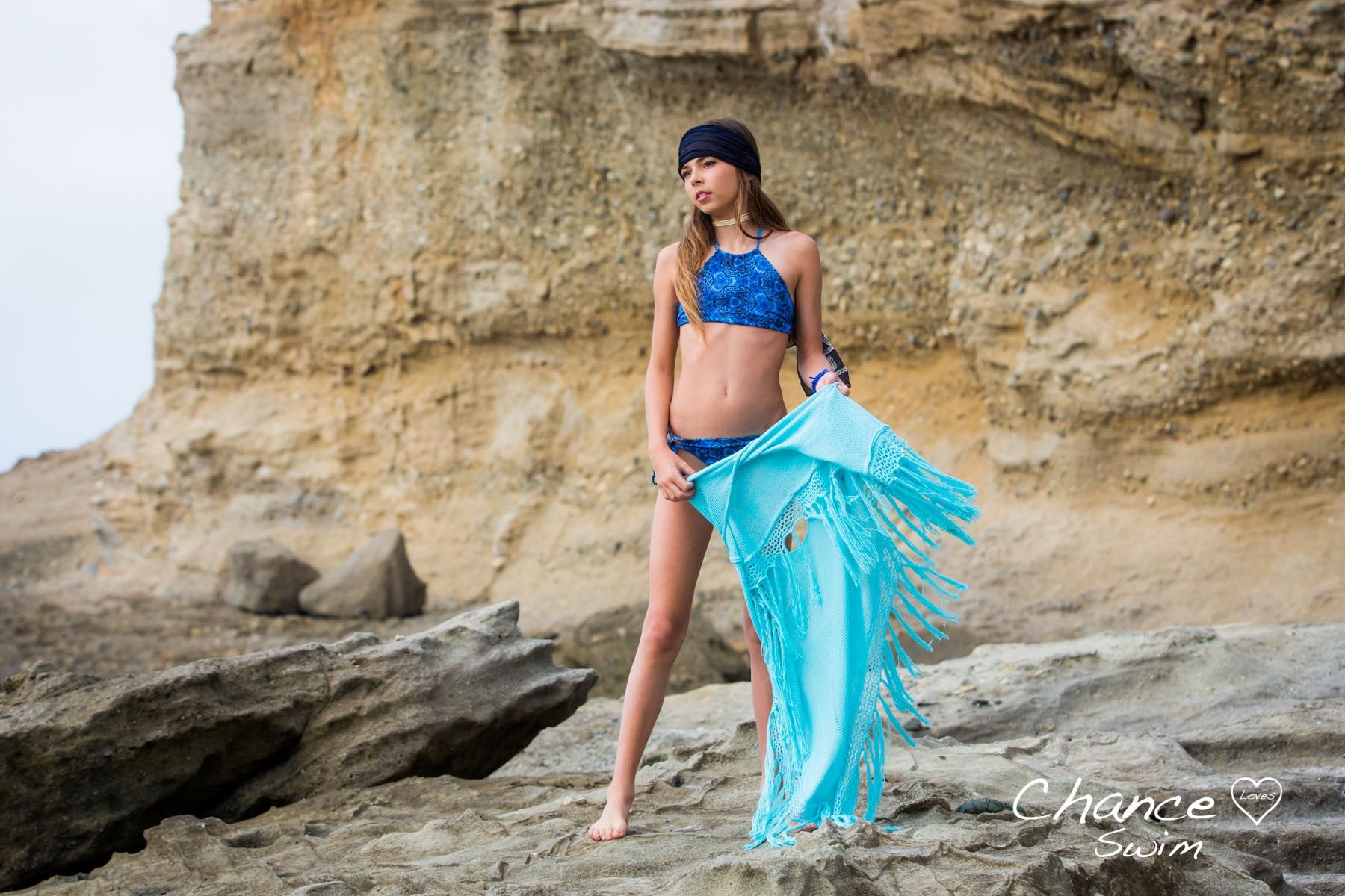 Girl Standing on Rock Tide Pools Wearing the Blue Currents Tween Girl Tankini Set - Chance Loves Swimwear